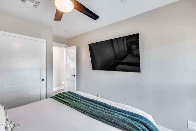 bedroom with visible vents, baseboards, and ceiling fan