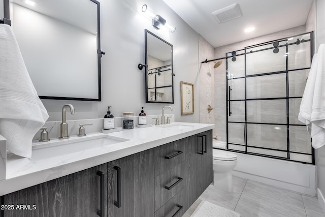 full bathroom featuring visible vents, a sink, shower / bath combination with glass door, and toilet