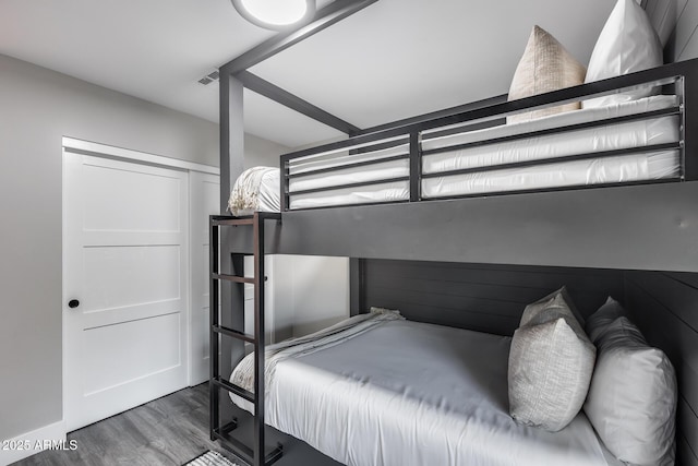 bedroom with visible vents and wood finished floors