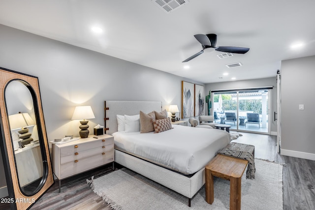 bedroom featuring visible vents, wood finished floors, and access to exterior