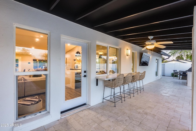 view of patio with ceiling fan and outdoor dry bar