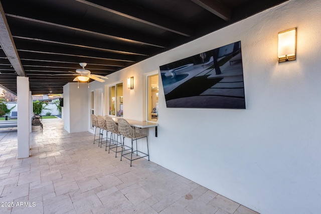 view of patio / terrace featuring outdoor dry bar and ceiling fan