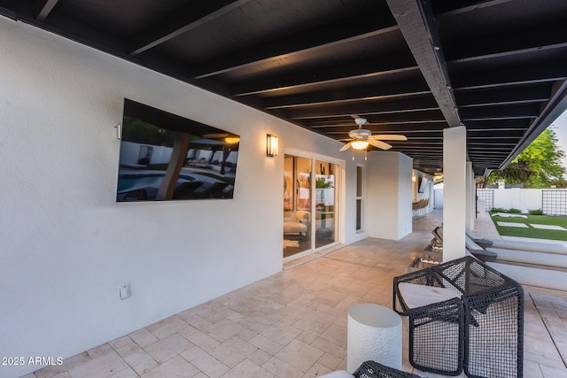 view of patio / terrace with a ceiling fan and fence