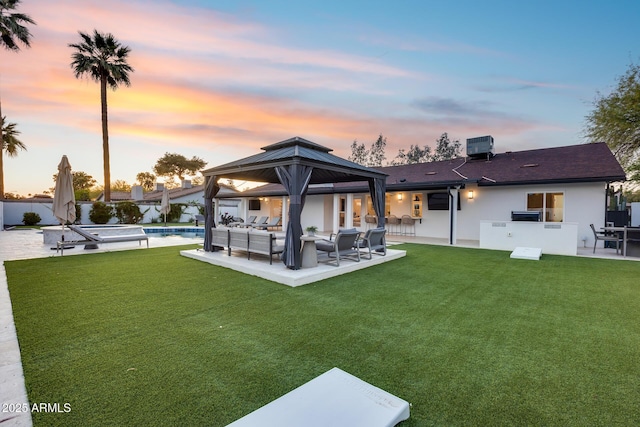 back of property featuring a gazebo, a fenced in pool, a fenced backyard, a patio, and outdoor lounge area