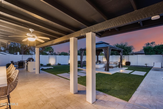 view of patio featuring a gazebo, a fenced backyard, and a ceiling fan