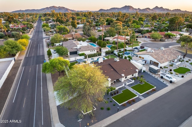 aerial view at dusk featuring a residential view and a mountain view