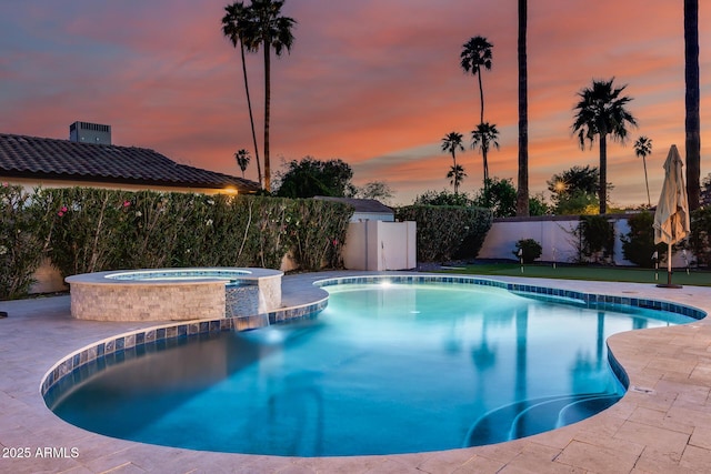 view of swimming pool with fence, an in ground hot tub, a fenced in pool, and a patio area