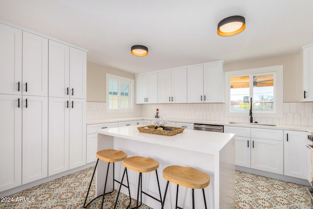 1921 E Yale St, Phoenix, AZ 85006 - kitchen with a breakfast bar, tasteful backsplash, dishwasher, and light countertops