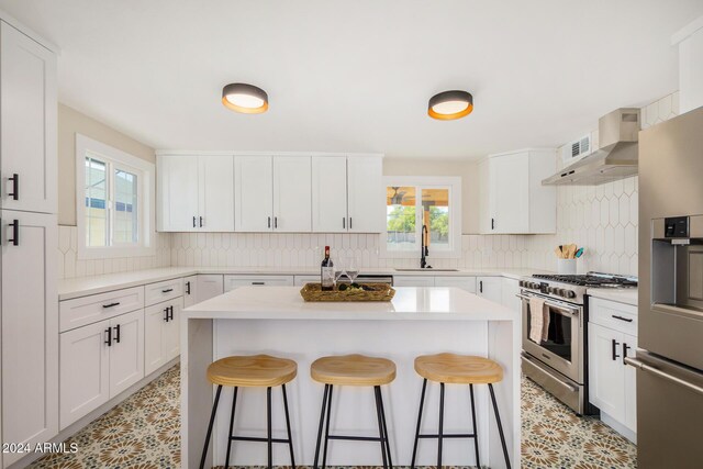 1921 E Yale St, Phoenix, AZ 85006 - kitchen featuring appliances with stainless steel finishes, a breakfast bar area, plenty of natural light, and tasteful backsplash