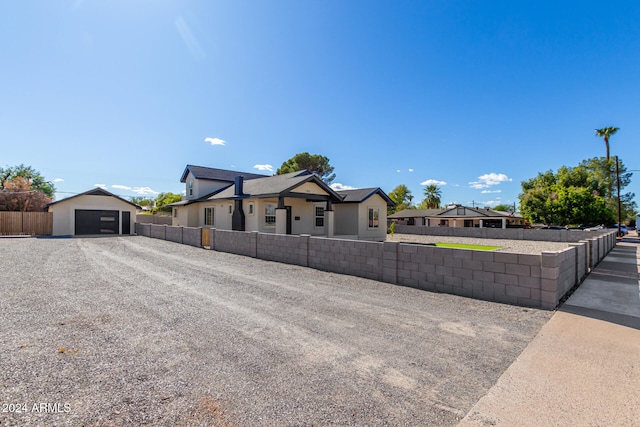 view of front facade featuring an outbuilding and a garage