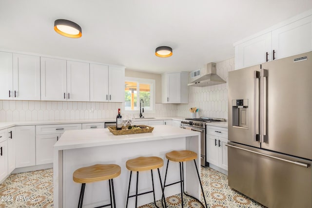 1921 E Yale St, Phoenix, AZ 85006 - kitchen featuring stainless steel appliances, extractor fan, a kitchen breakfast bar, and decorative backsplash