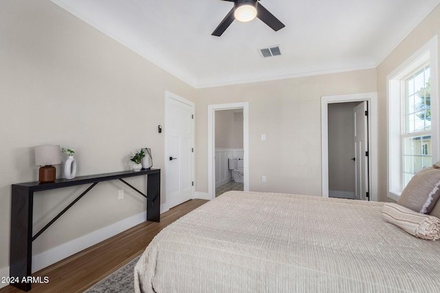 bedroom with dark hardwood / wood-style flooring, connected bathroom, and ceiling fan