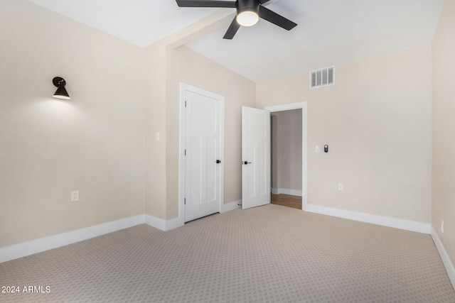 carpeted spare room with ceiling fan