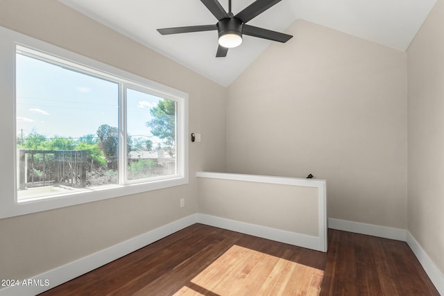 empty room featuring ceiling fan, dark hardwood / wood-style flooring, and vaulted ceiling