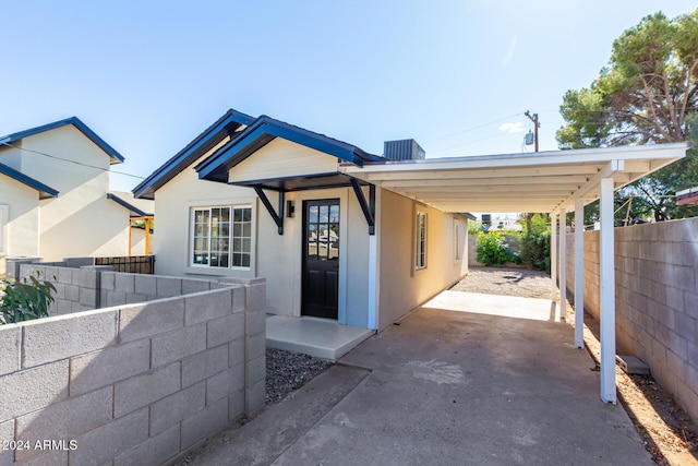 1921 E Yale St, Phoenix, AZ 85006 - view of front facade with a fenced backyard, concrete driveway, an attached carport, and stucco siding