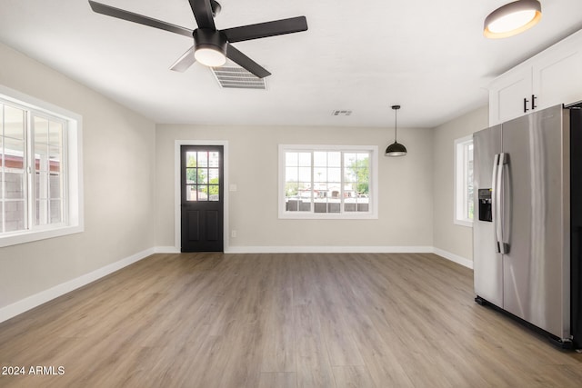 interior space with light hardwood / wood-style flooring and ceiling fan