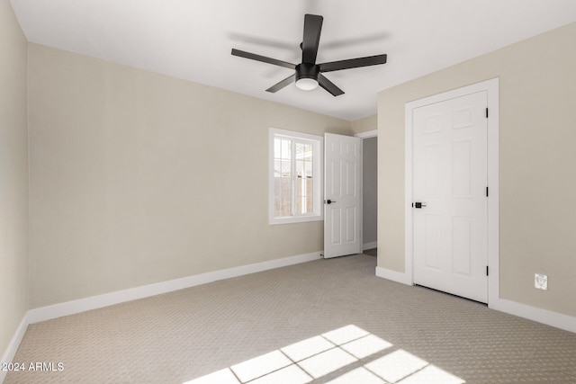 unfurnished bedroom featuring light colored carpet and ceiling fan