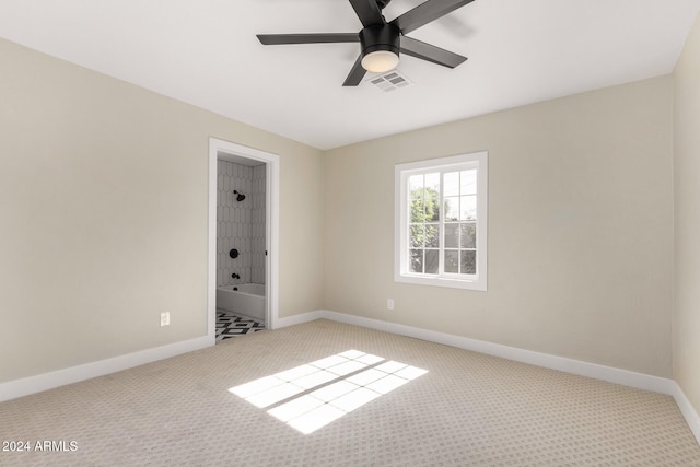 carpeted spare room with ceiling fan