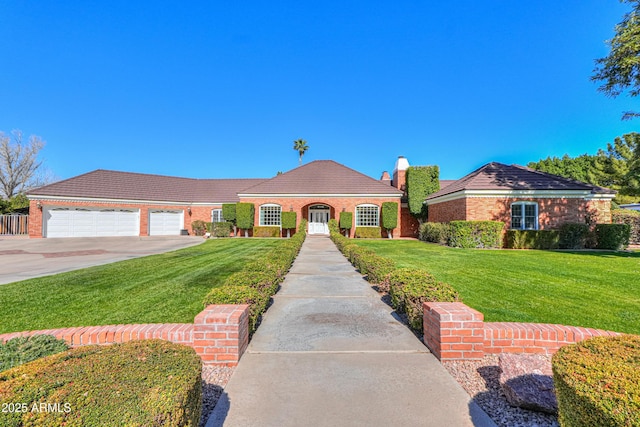 mediterranean / spanish-style house with a garage, a front yard, driveway, and a tiled roof