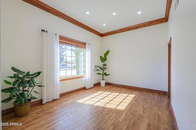 empty room featuring ornamental molding, recessed lighting, light wood-style flooring, and baseboards