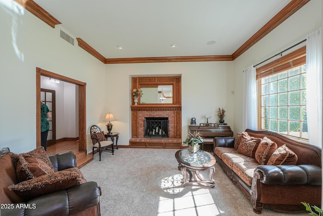 carpeted living room featuring a brick fireplace, baseboards, visible vents, and ornamental molding