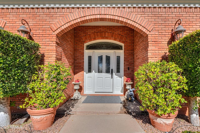 doorway to property with brick siding