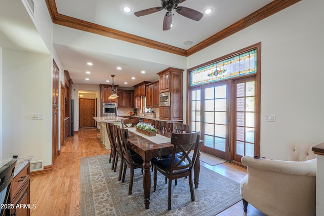 dining area with light wood-style floors, visible vents, crown molding, and recessed lighting