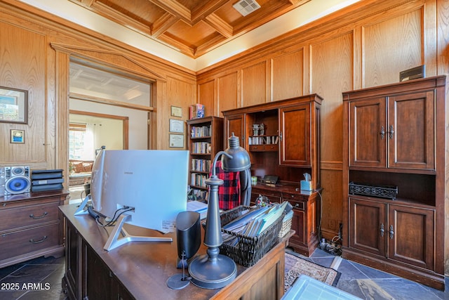 office space featuring wooden walls, visible vents, coffered ceiling, stone finish floor, and beamed ceiling