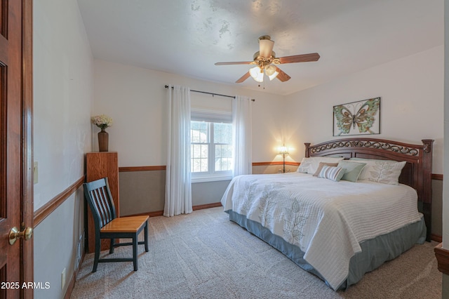 bedroom featuring light carpet, ceiling fan, and baseboards