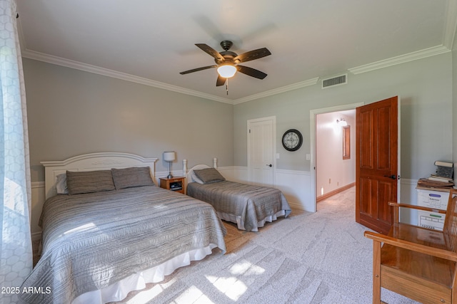 bedroom with light carpet, ceiling fan, visible vents, and ornamental molding