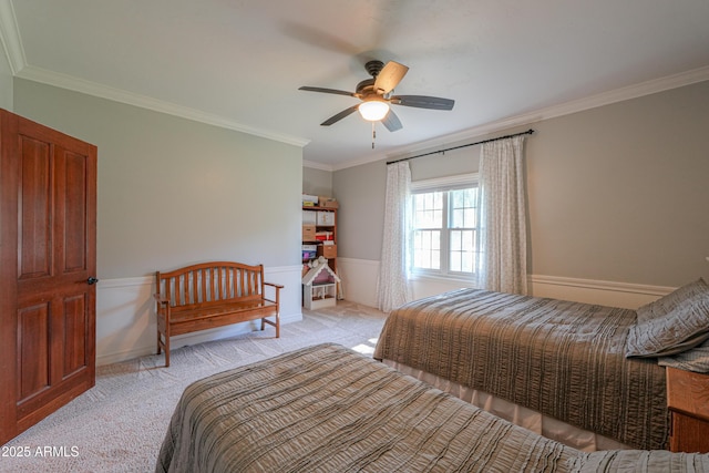 bedroom featuring crown molding, baseboards, a ceiling fan, and light colored carpet