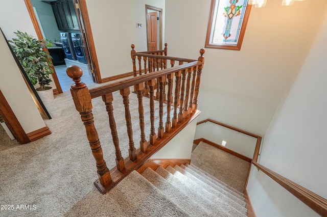 staircase featuring carpet and baseboards