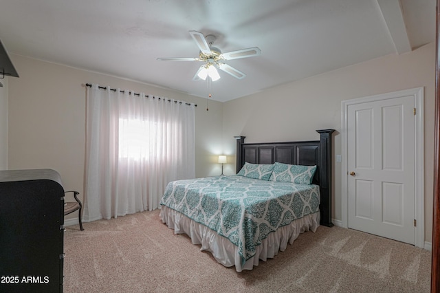 bedroom featuring ceiling fan and carpet