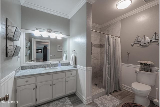 full bath featuring a wainscoted wall, a shower stall, and crown molding