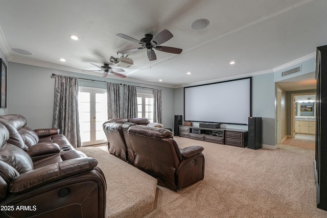 cinema featuring light carpet, french doors, visible vents, and crown molding