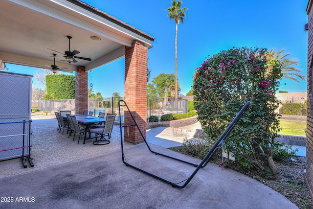 view of patio with a ceiling fan, outdoor dining space, and a fenced backyard