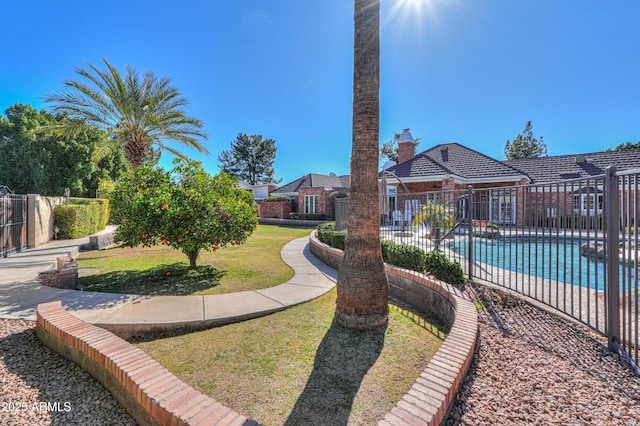 view of yard with fence and a fenced in pool