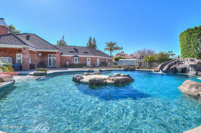 outdoor pool with fence and a water slide