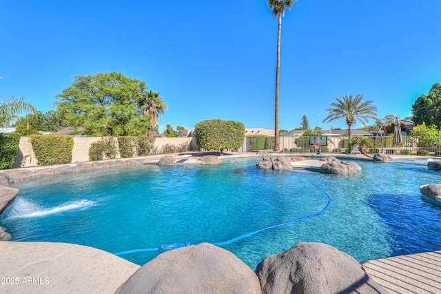 view of swimming pool featuring a fenced in pool and fence