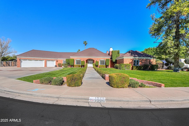 view of front facade featuring an attached garage, a tiled roof, concrete driveway, and a front yard