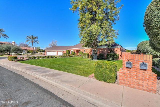 ranch-style home with a garage, fence, and a front lawn