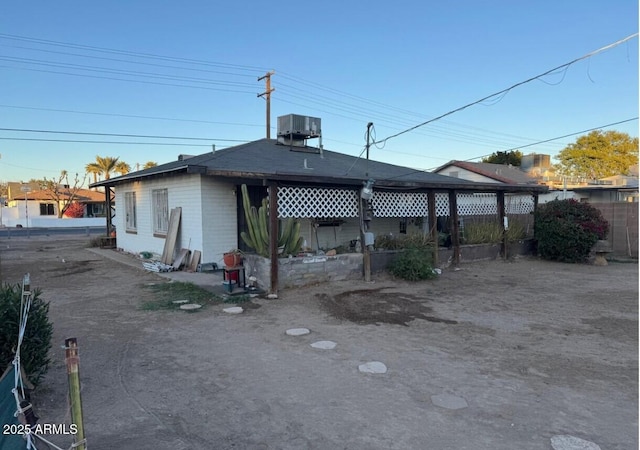 back of house featuring fence and central AC unit