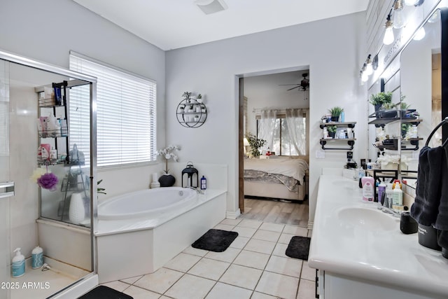 ensuite bathroom featuring ensuite bathroom, a stall shower, a sink, tile patterned flooring, and a bath