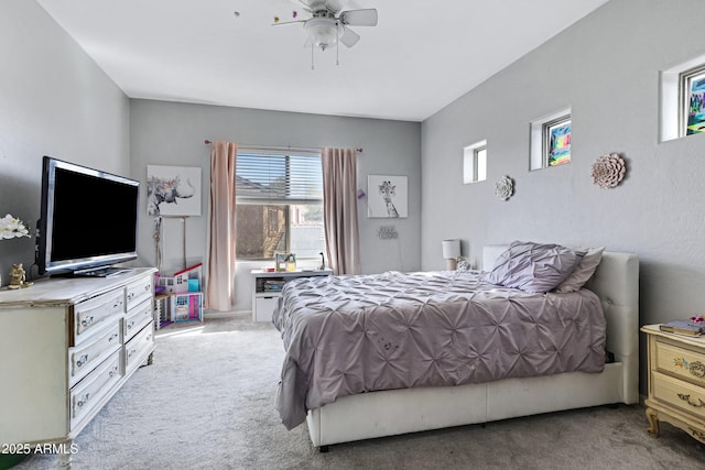 bedroom featuring light carpet and ceiling fan