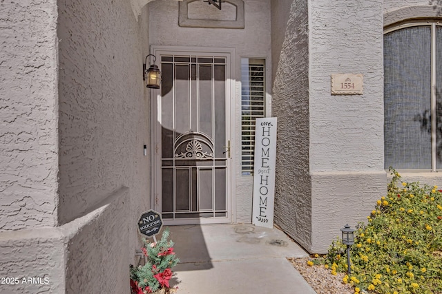 doorway to property with stucco siding