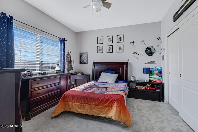 bedroom with carpet, a closet, and a ceiling fan