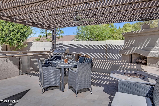 view of patio / terrace with outdoor dining area, a fenced backyard, a pergola, and an outdoor fireplace