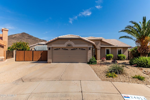 24813 N 55th Dr, Glendale, AZ 85310 - view of front facade featuring a tiled roof, stucco siding, an attached garage, driveway, and a mountain view