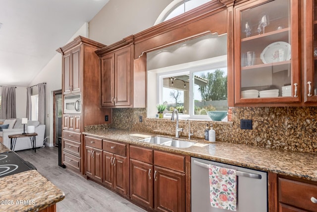 24813 N 55th Dr, Glendale, AZ 85310 - kitchen featuring stainless steel dishwasher, a sink, white microwave, backsplash, and vaulted ceiling