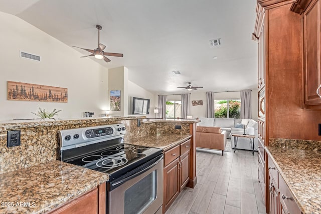 24813 N 55th Dr, Glendale, AZ 85310 - kitchen with stainless steel range with electric stovetop, ceiling fan, vaulted ceiling, open floor plan, and brown cabinetry